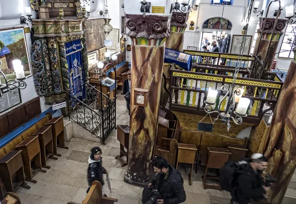 A family celebrating a bar mitzvah with the congregation showering the child with candy