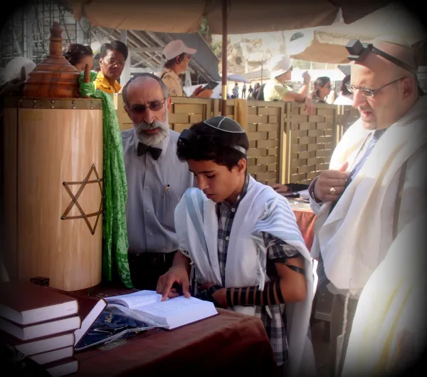 A Bar Mitzvah boy wearing a tallit for the first time