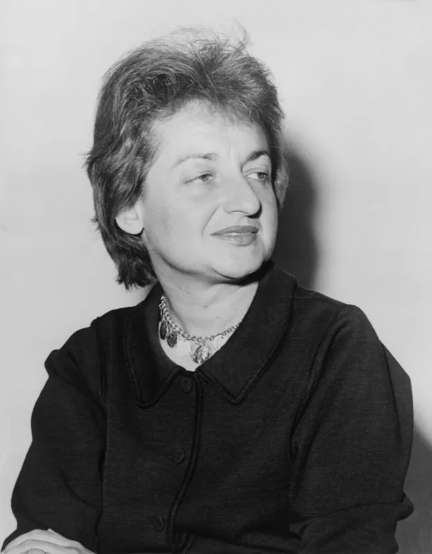 Betty Friedan speaking at a podium