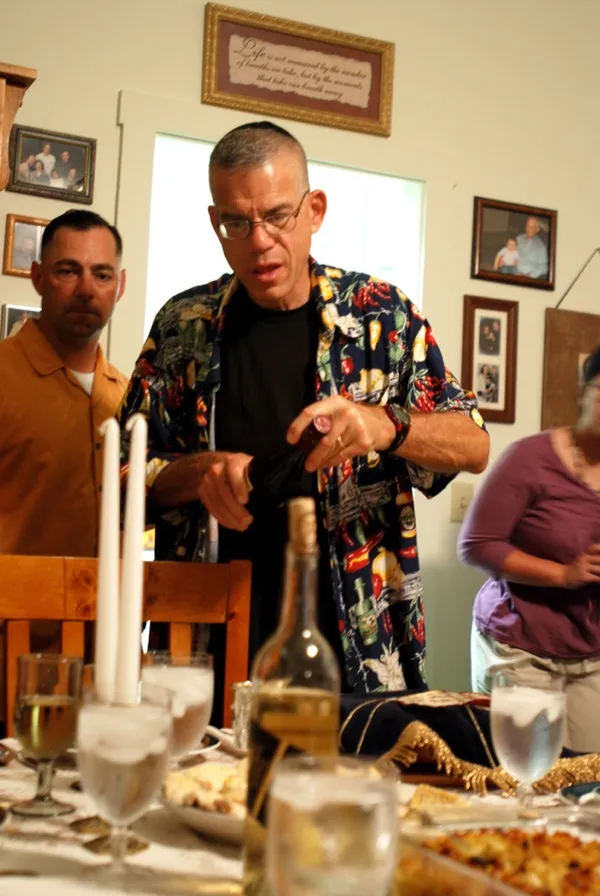 A Shabbat dinner table with candles, wine, and challah, set for the traditional blessings