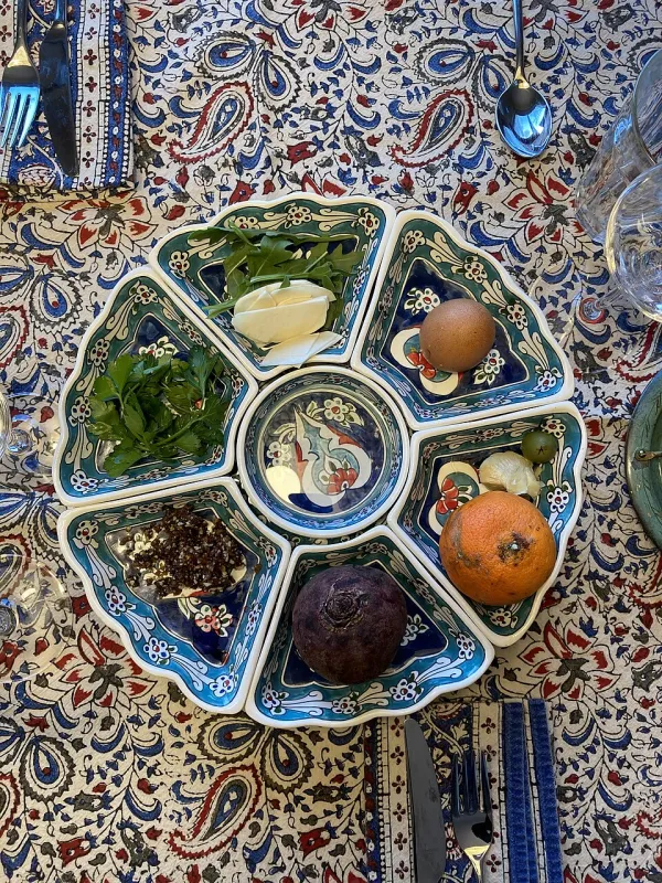 Dark, spiced Yemenite charoset in a small bowl with matzah