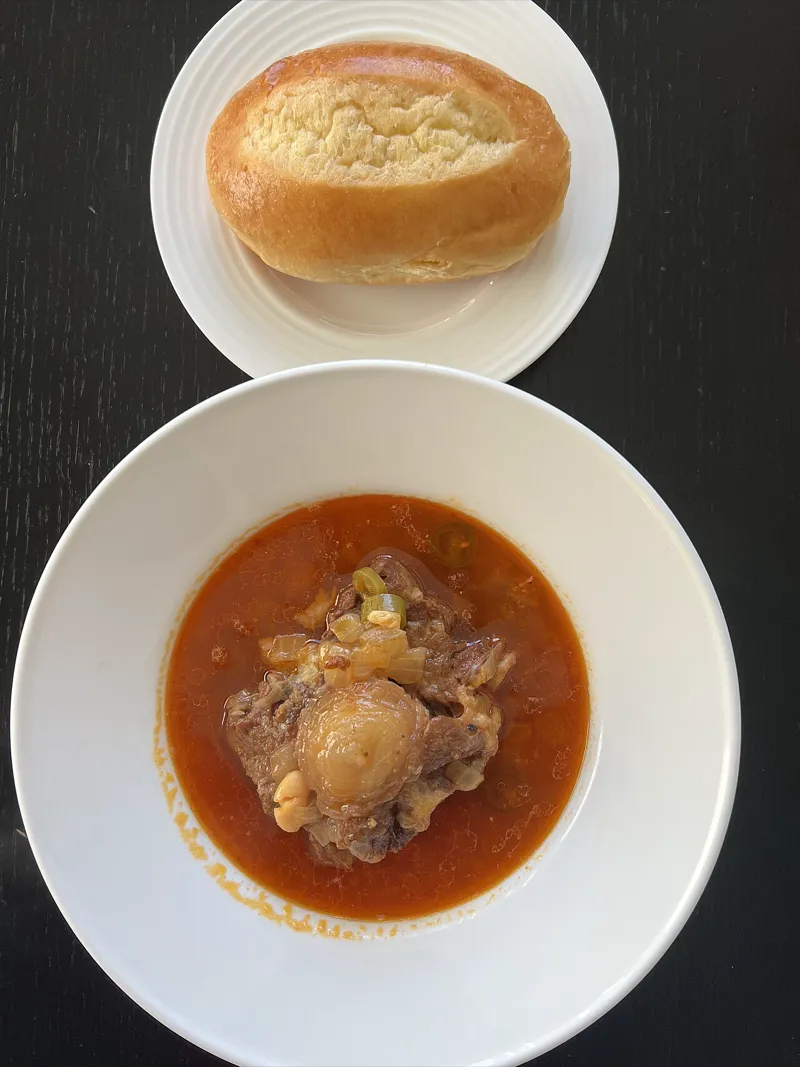 Steaming pot of cholent with meat, beans, and potatoes
