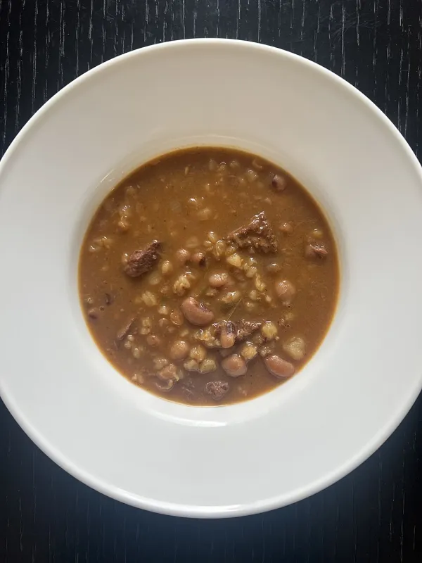 Moroccan skhina with chickpeas, dates, and eggs