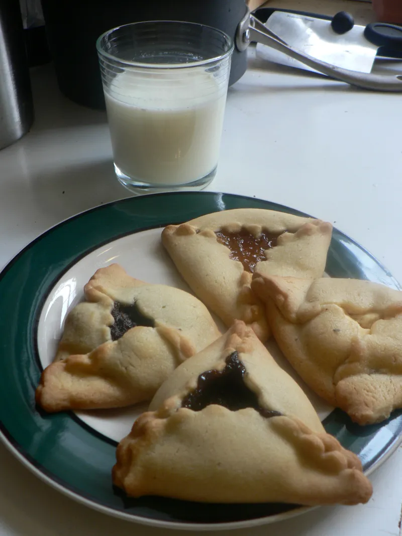 Hamantaschen dough circles with various fillings ready to be folded