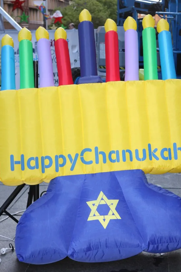 Children playing dreidel with chocolate coins (gelt) on a table during Hanukkah