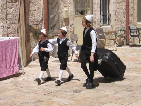 Hasidic children in traditional clothing preparing for Shabbat in the Mea Shearim neighborhood of Jerusalem