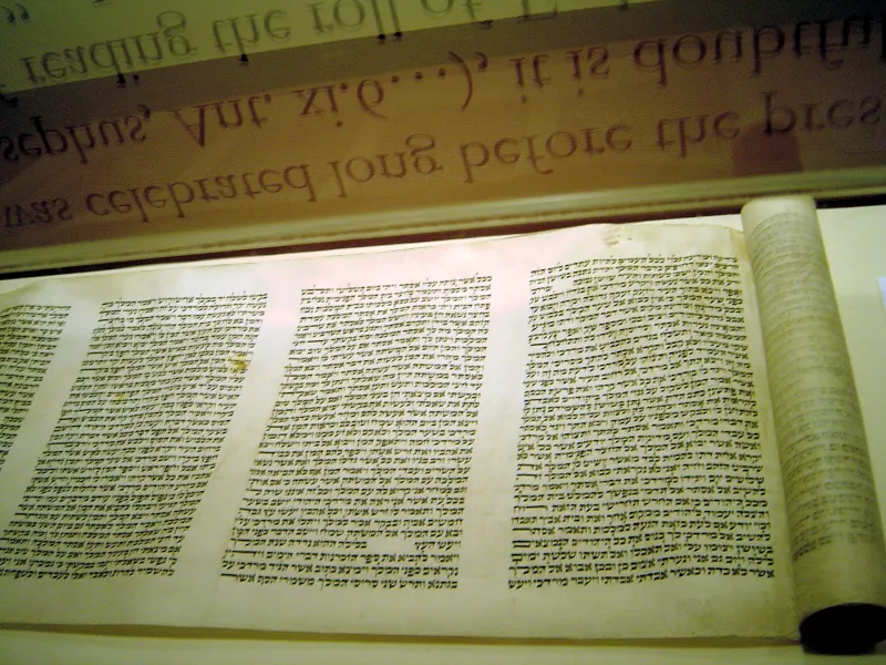 Hebrew text on a handwritten scroll — the script of the Torah and modern Israel