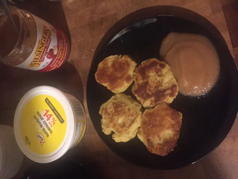 Golden latkes (potato pancakes) served with sour cream and applesauce