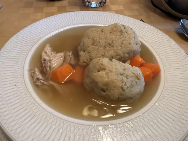A bowl of matzah ball soup served during a Passover Seder meal