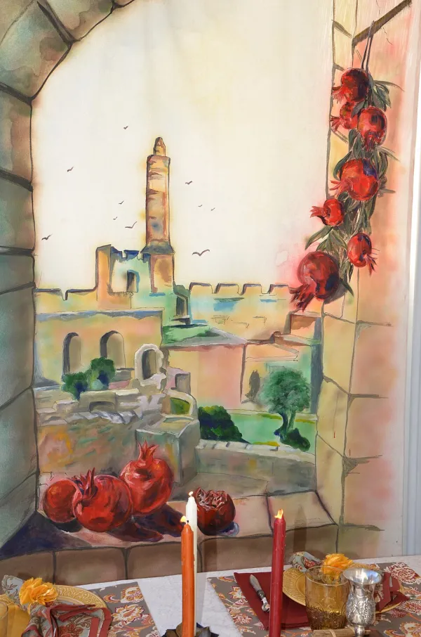 Children hanging decorations inside a sukkah