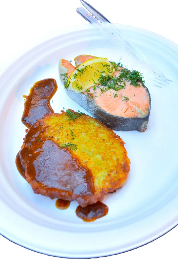 Family gathered around a lit menorah playing dreidel