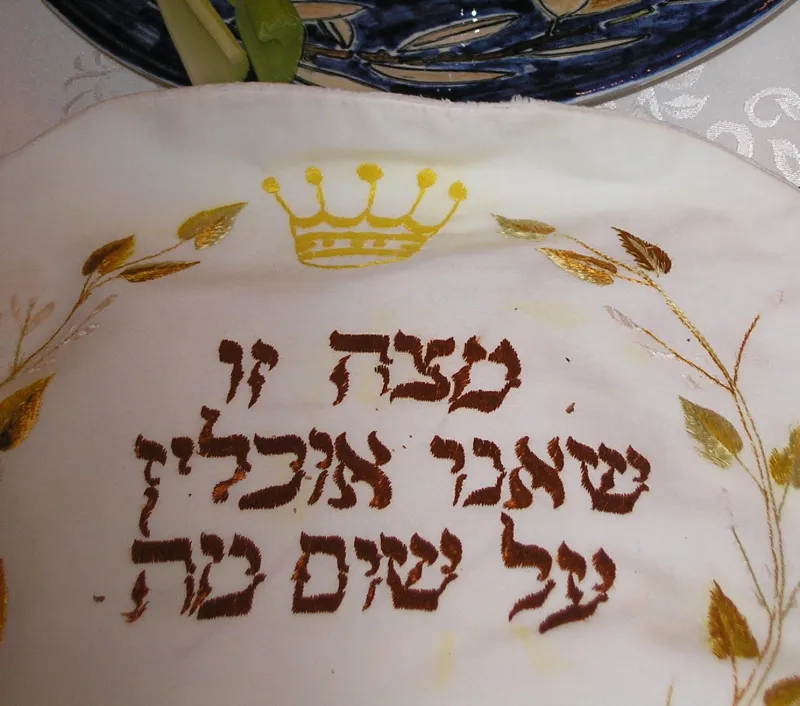 Beautifully set Passover seder table with seder plate, matzah, and wine
