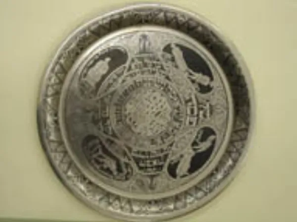 A seder table set with the traditional seder plate and Haggadot