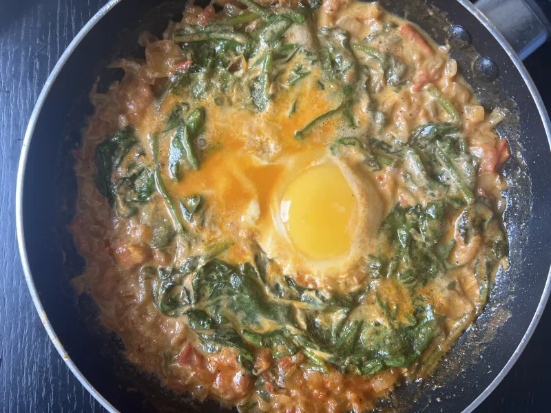 Shakshuka — eggs poached in spiced tomato sauce in a cast iron skillet