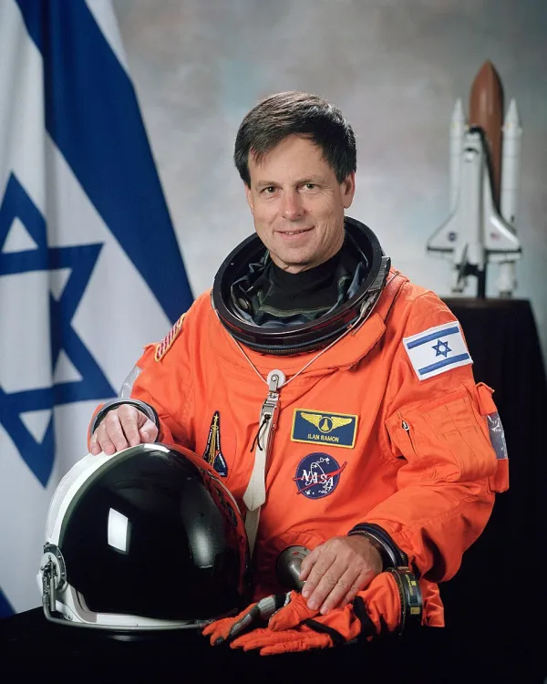 Ilan Ramon in his NASA spacesuit, smiling, with the Israeli flag on his shoulder