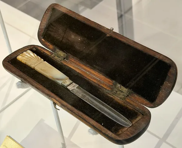 Torah scroll opened to a passage with Hebrew names visible