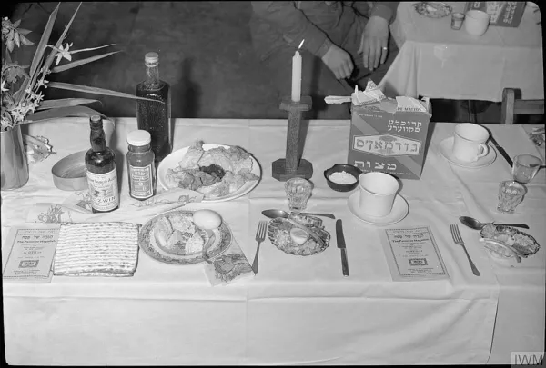 A pot of kubaneh bread being pulled apart, showing the soft, golden layers