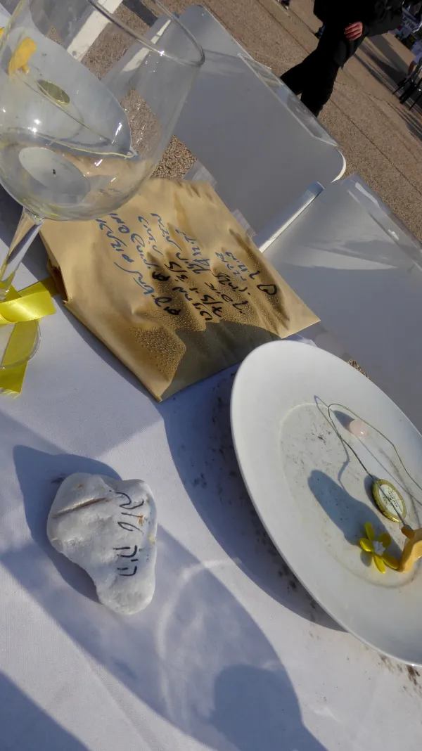 A bottle of kosher wine and flowers as gifts for a host