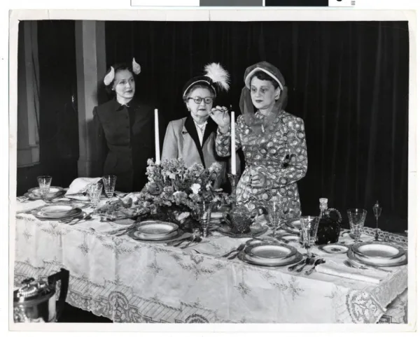 A family singing together at a Shabbat dinner table
