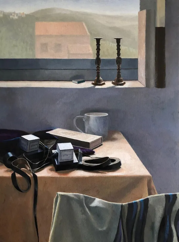 Morning light streaming through a window with tefillin and prayer book on a table