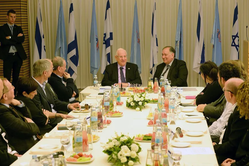 A rainbow arcing over a green landscape