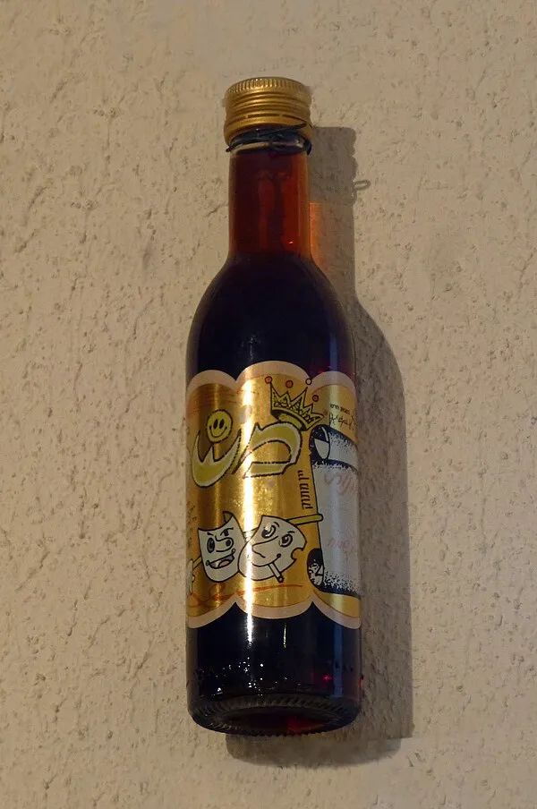 A family making kiddush over wine on Shabbat evening