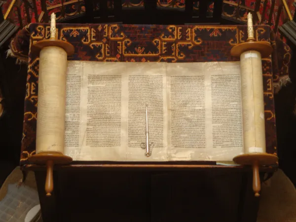 An open Torah scroll — the foundational text of Judaism and the shared scripture with Christianity's Old Testament