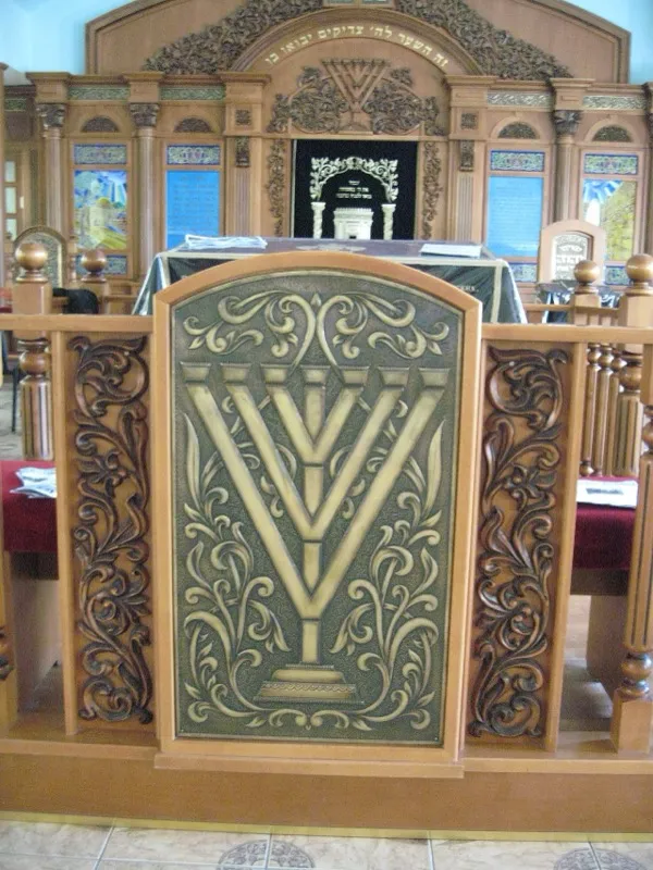 Interior of a synagogue with worshippers gathered for prayer