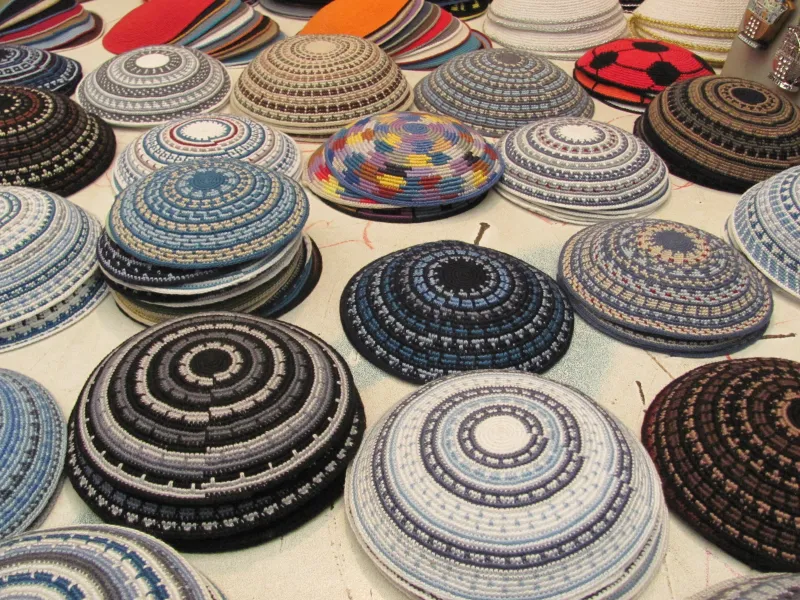 A collection of kippot (Jewish head coverings) in various styles and colors