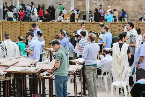 Jewish men wearing kippot while praying at the Western Wall in Jerusalem