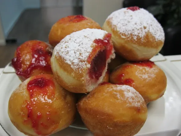 Classic Hanukkah sufganiyot — jelly-filled donuts dusted with powdered sugar