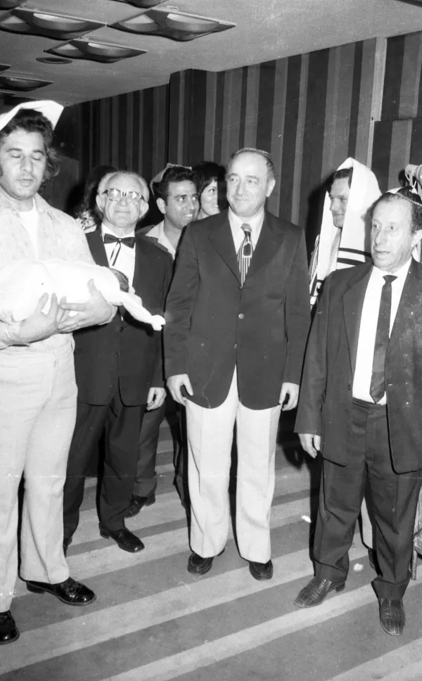 A Brit Milah ceremony with family gathered around