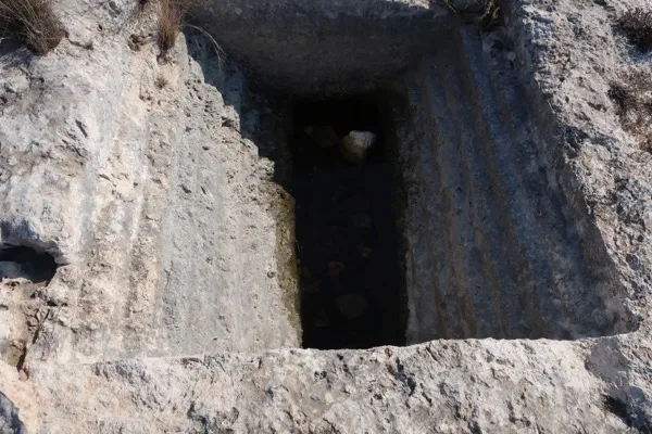 An ancient mikveh carved into rock, showing the stepped descent into the immersion pool