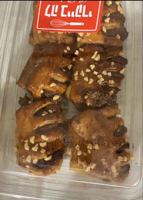 Rugelach dough rolled out with chocolate filling being spread