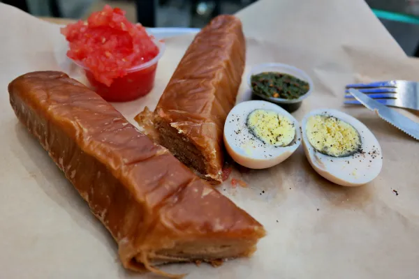 Jachnun — a traditional Yemenite Jewish Shabbat pastry served with grated tomato and a boiled egg