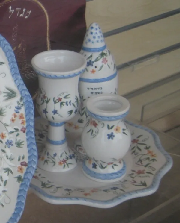 Havdalah ceremony with braided candle, wine, and spice box