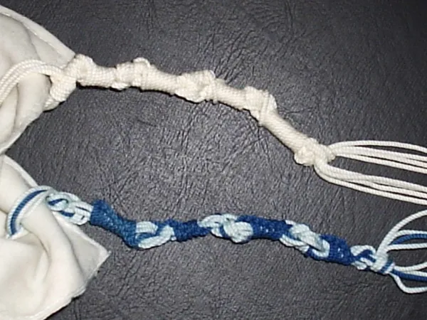 Close-up of tzitzit fringes showing the intricate pattern of knots and windings on a tallit