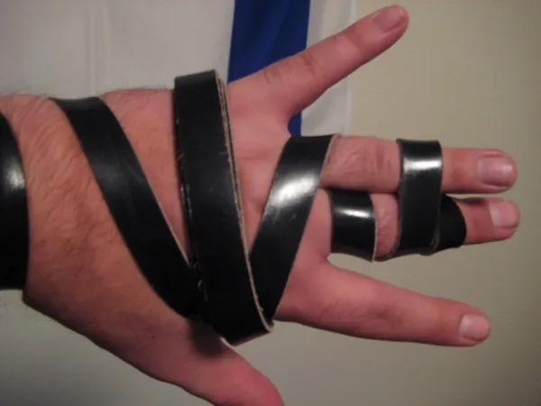 Tefillin shel yad (arm tefillin) wrapped on the left arm with the leather strap wound around the forearm