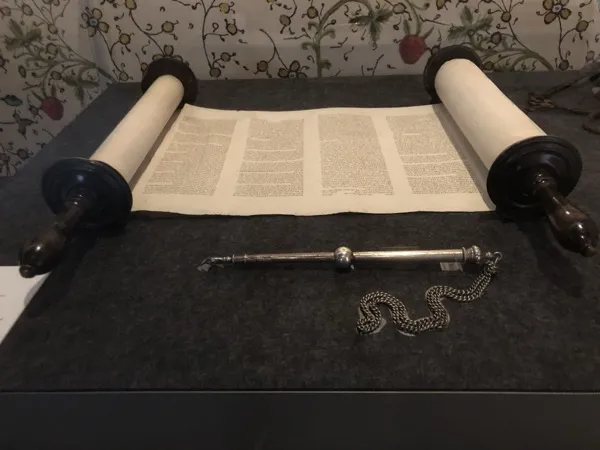 Torah scroll open for reading, showing the handwritten Hebrew text