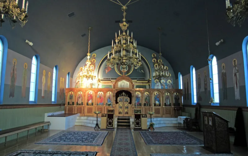 The elegant interior of a synagogue with rows of seating and beautiful architectural details