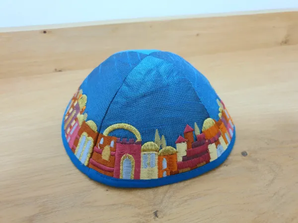 A collection of kippot (Jewish skullcaps) in various colors and styles