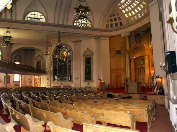 The beautiful interior of a historic synagogue showing ornate architecture and seating