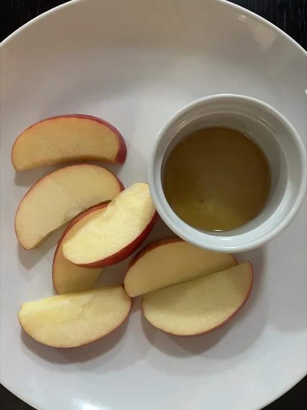 Apples and a bowl of honey on a Rosh Hashanah table