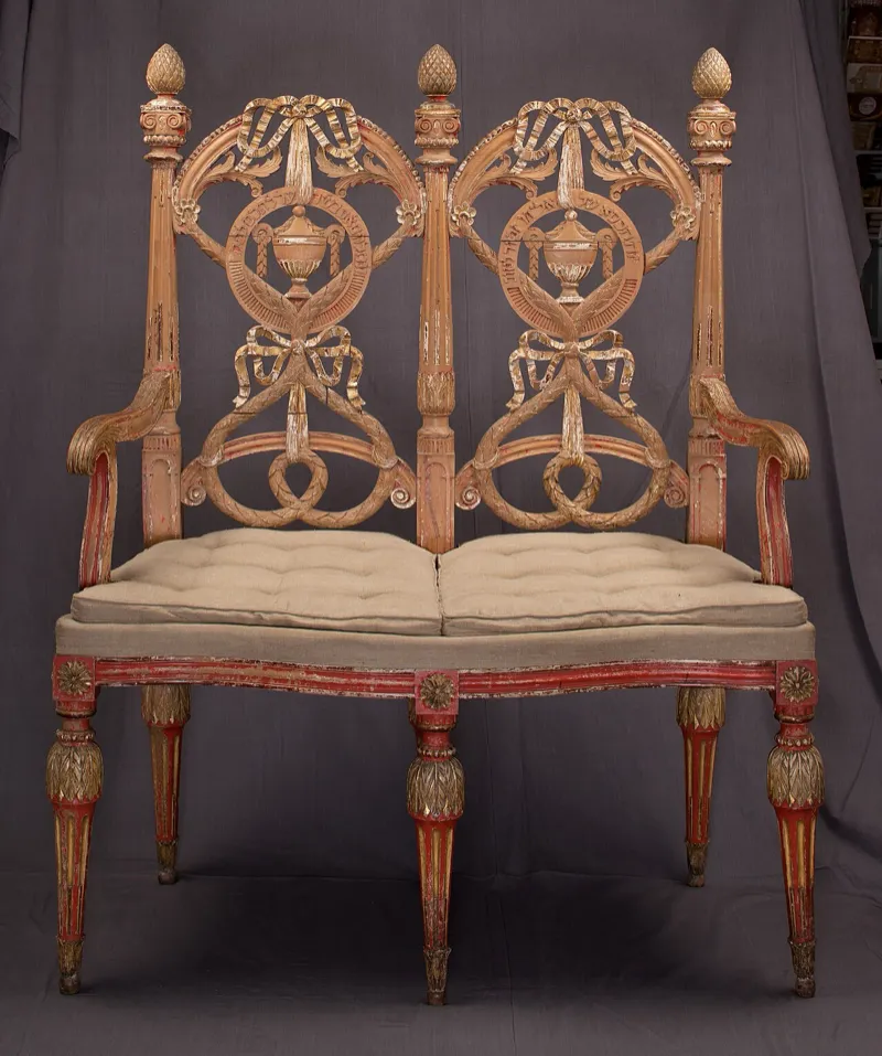 Ceremonial items for a brit milah including a kiddush cup and pillow