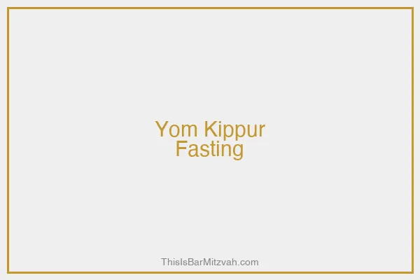 A memorial candle burning alongside a prayer book on Yom Kippur