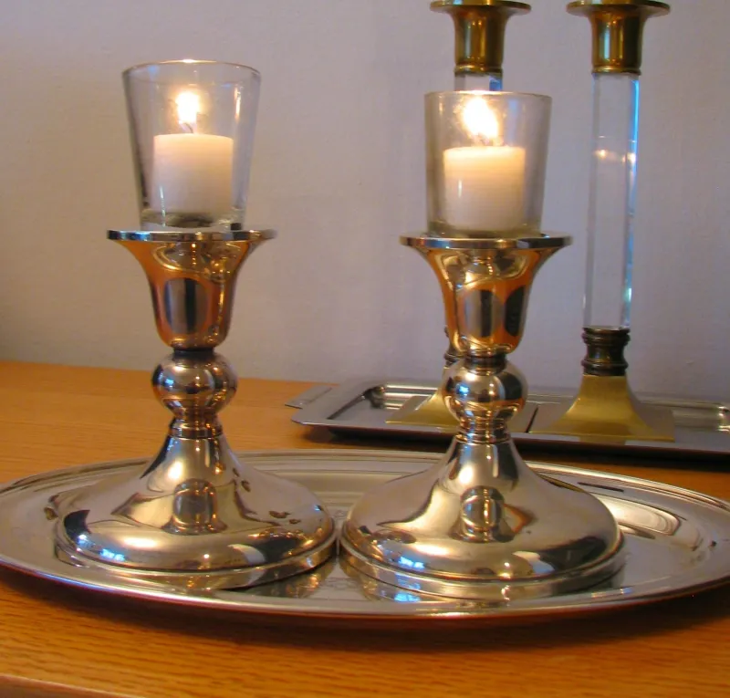 Shabbat candles glowing warmly — lit every Friday evening to welcome the day of rest