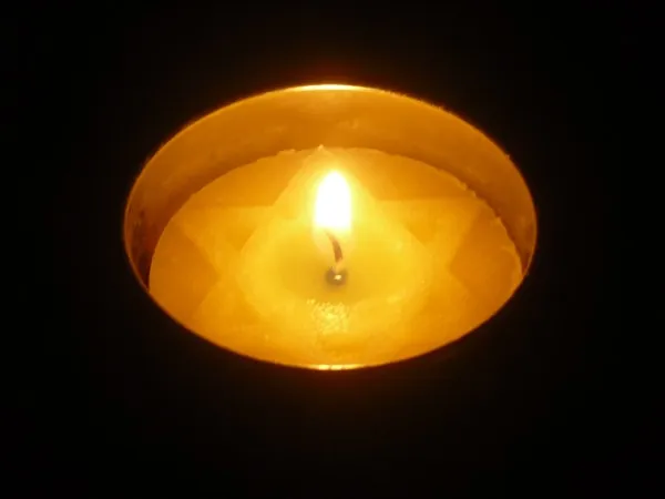A Yom HaShoah memorial candle burning in remembrance of Holocaust victims